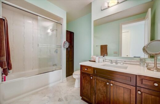 Edington bathroom with tub-shower and wood vanity