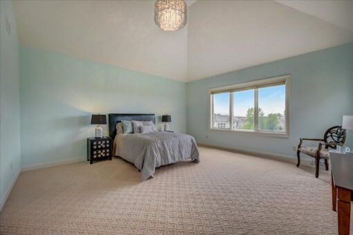 Edington bedroom with ceiling fan and large windows