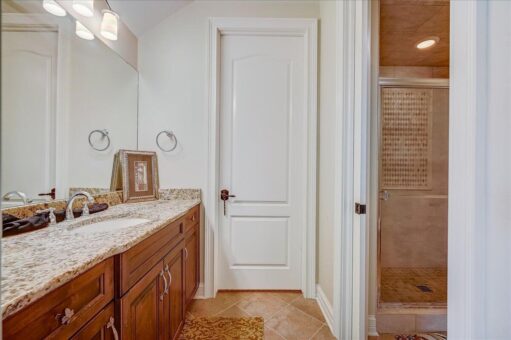 Edington bathroom with wood vanity and door