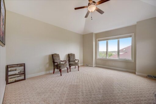 Edington bedroom with ceiling fan and windows