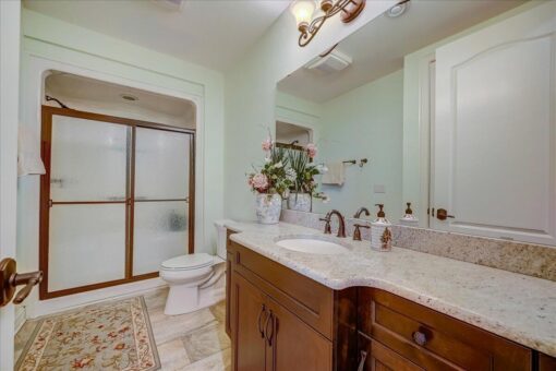 Edington bathroom with wood vanity and glass shower