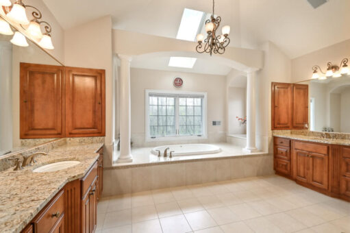 Benington primary bath soaking tub with columns and skylight