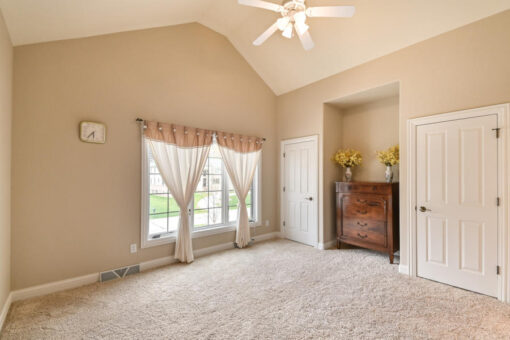 Benington bedroom with vaulted ceiling and ceiling fan
