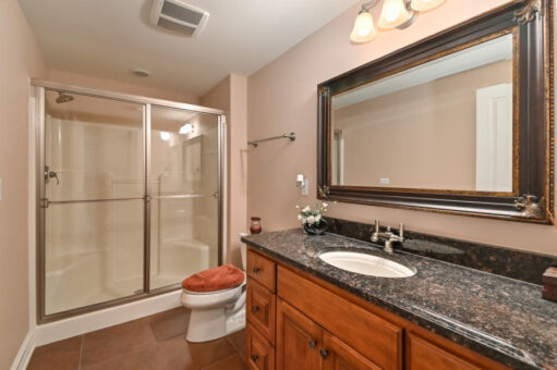 Benington bathroom with granite vanity and glass shower