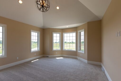 Stone Creek bedroom with bay windows and ceiling fan