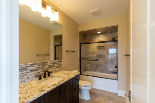 Stone Creek bathroom with dark vanity and tub