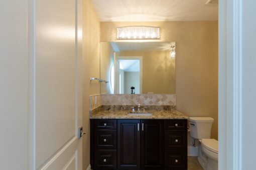 Stone Creek bathroom with dark vanity and mosaic backsplash