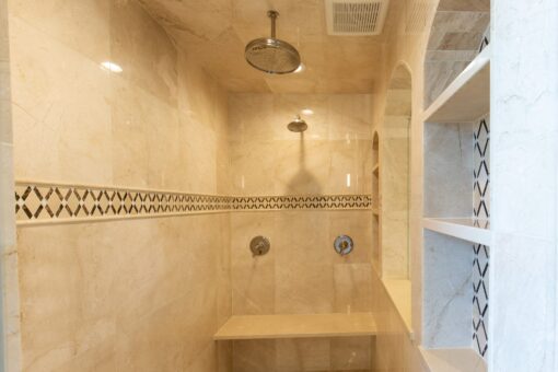 Stone Creek walk-in shower with tile border and rain head