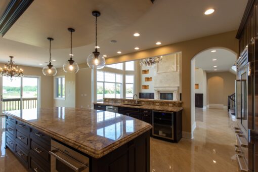 Stone Creek kitchen island with granite and pendant lights