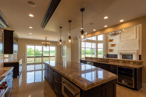 Stone Creek kitchen with granite islands and pendant lights