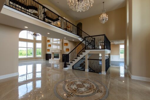 Stone Creek foyer staircase and balcony with marble medallion floor