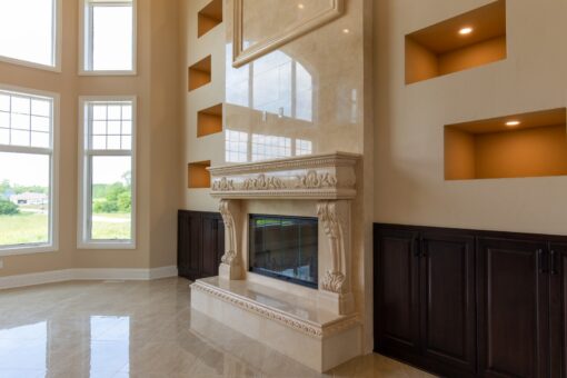 Stone Creek great room fireplace and tall windows