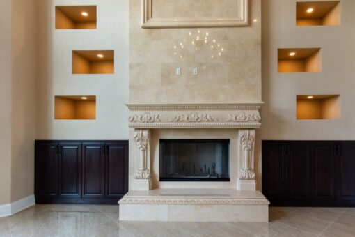 Stone Creek great room carved stone fireplace with built-ins