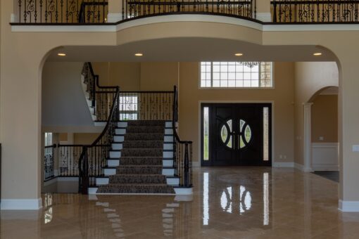 Stone Creek foyer double staircase with wrought-iron railing
