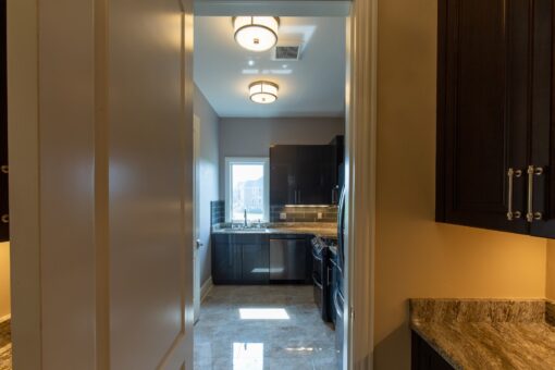 Stone Creek butler's pantry with dark cabinetry and window