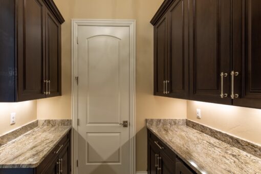 Stone Creek butler's pantry with dark cabinetry
