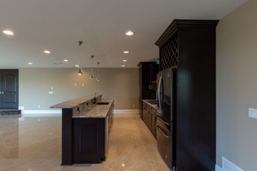 Stone Creek lower-level kitchen with dark cabinetry