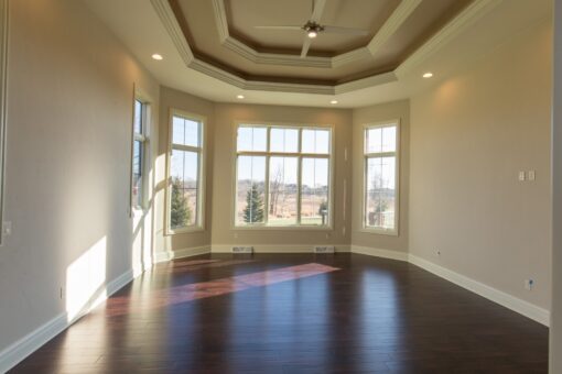 Callista bedroom with tray ceiling and hardwood floors