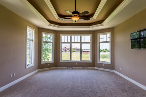 Richland primary bedroom with bay windows and tray ceiling
