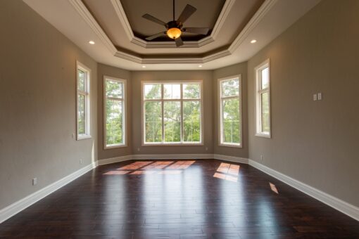 Kingfogl custom home bedroom with tray ceiling and hardwood floors
