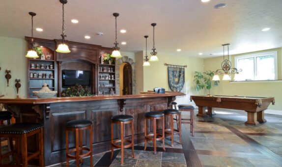 Buckingham lower-level bar with dark wood and pendant lights