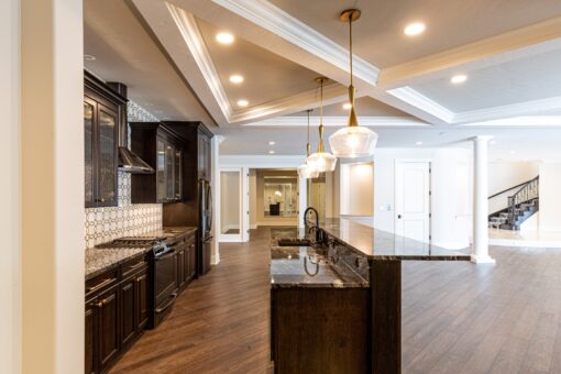 Prescott lower-level kitchen and bar with dark cabinetry
