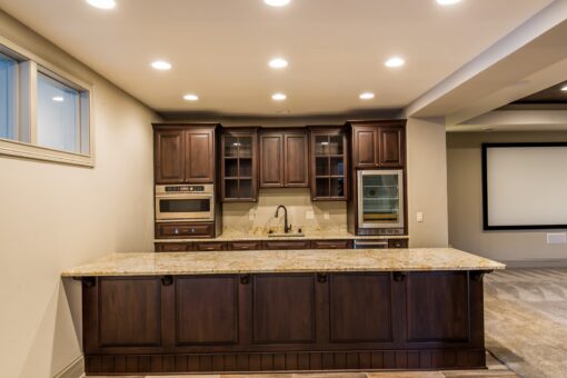 Compton lower-level kitchen with dark cabinetry