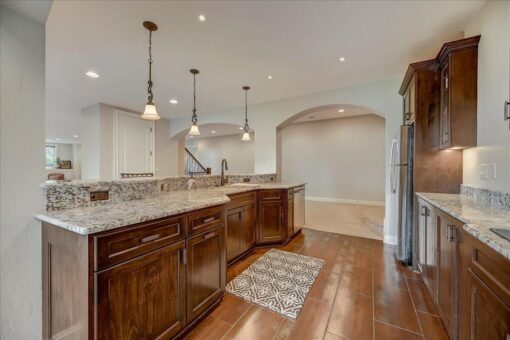 Edington lower-level bar with wood cabinetry and pendants