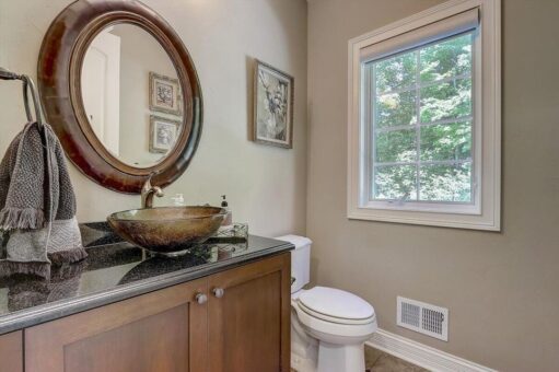 Talon powder room with round mirror and vessel sink