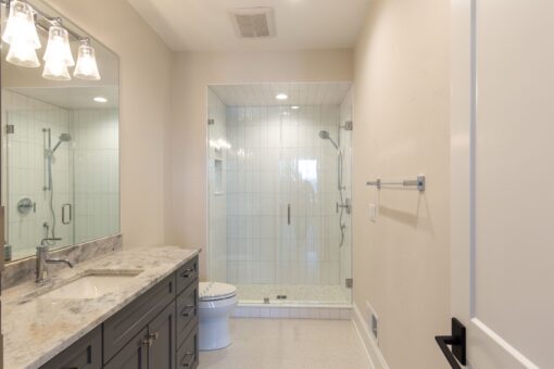 Sanctuary bathroom with glass shower and white tile