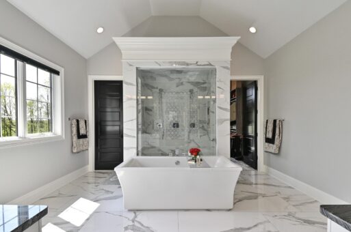 Kingfogl custom home primary bath freestanding tub in front of a marble walk-in shower