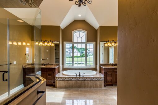 Richland primary bath soaking tub beneath an arched window