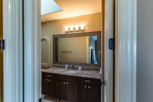 Presidio bathroom with dark vanity and granite top