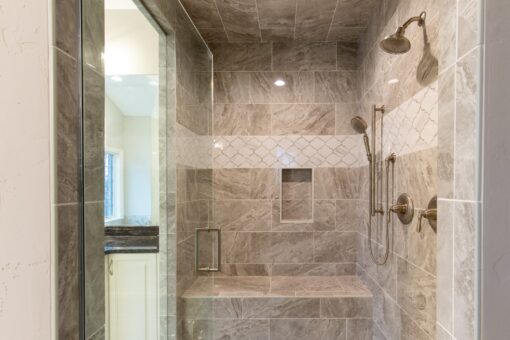Woodview walk-in shower with stone tile and bench