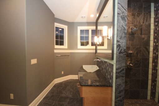 Kingfogl custom home bathroom with dark slate tile shower and vessel sink