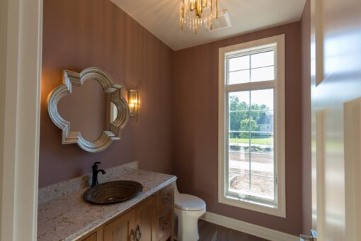 Auburn powder room with decorative mirror and vessel sink