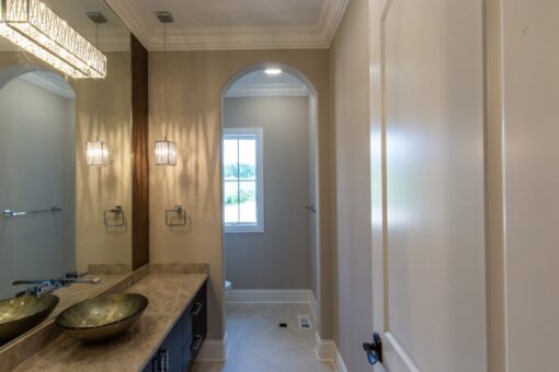 Kingfogl custom home bathroom with vessel sinks and arched doorway