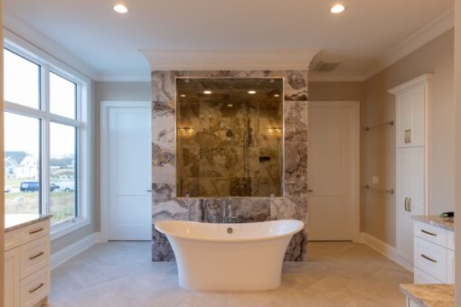 Sanctuary primary bath freestanding tub with stone wall