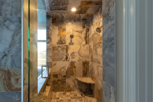 Sanctuary walk-in shower with natural stone tile