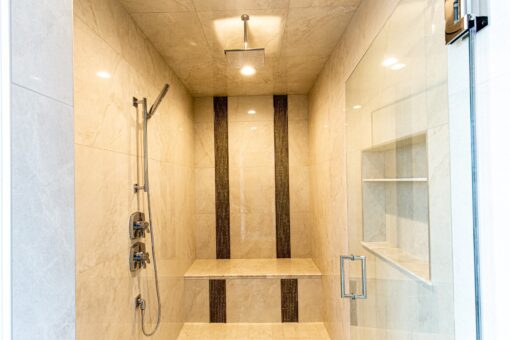 Saddlebrook walk-in shower with stone tile stripes