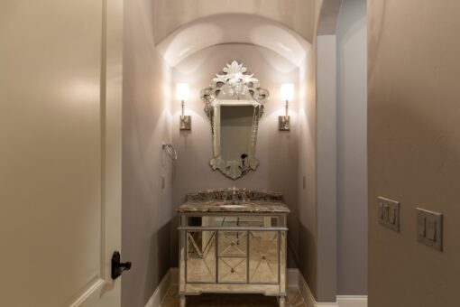 Grand Haven powder room with Venetian mirror and vanity