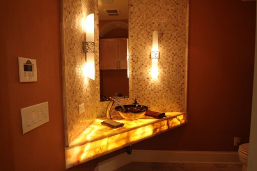 Kingfogl custom home powder room with backlit onyx vanity and vessel sink