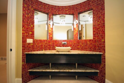 Haven bathroom with red mosaic tile and floating vanity