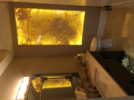 Kingfogl custom home powder room with backlit onyx feature wall