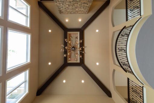 Rivendell ceiling with dark beam detail and chandelier