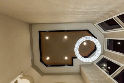 Kingfogl custom home tray ceiling with lit detail and ring chandelier
