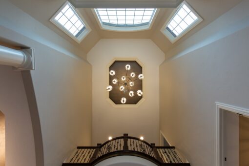 Woodview foyer ceiling with chandelier viewed from below