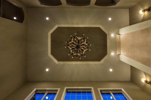 Kingfogl custom home octagonal tray ceiling with chandelier above a window wall