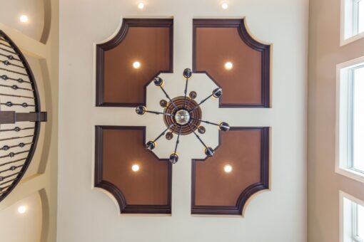 Kingfogl custom home ceiling with four curved inlay panels and chandelier