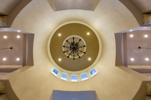 Kingfogl custom home domed ceiling with round clerestory windows and chandelier